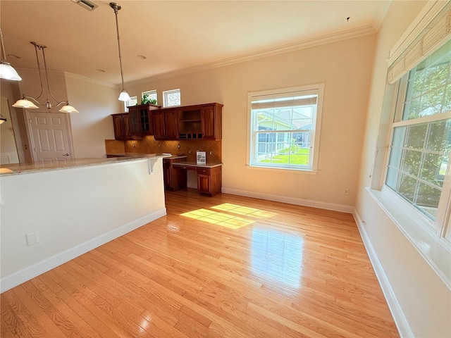88 Longview Way N, Palm Coast, FL 32137 - unfurnished living room featuring plenty of natural light, light wood-style flooring, crown molding, and baseboards