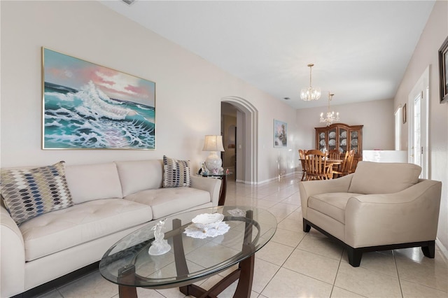 tiled living room featuring an inviting chandelier