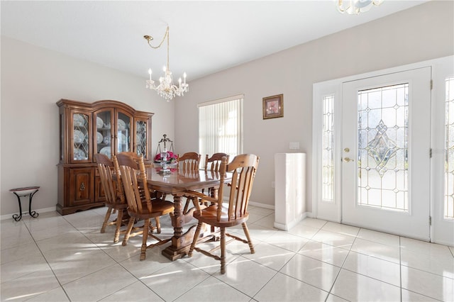 dining room with a notable chandelier, a healthy amount of sunlight, and light tile patterned flooring