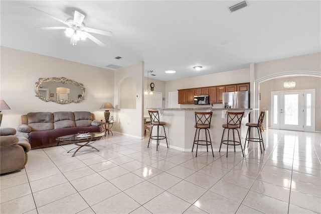 living room featuring ceiling fan and light tile patterned floors