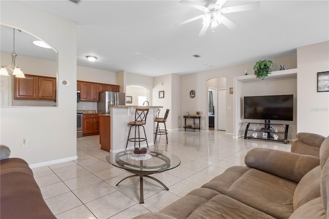 54 Fieldstone Ln, Palm Coast, FL 32137 - living area with arched walkways, ceiling fan, and light tile patterned floors