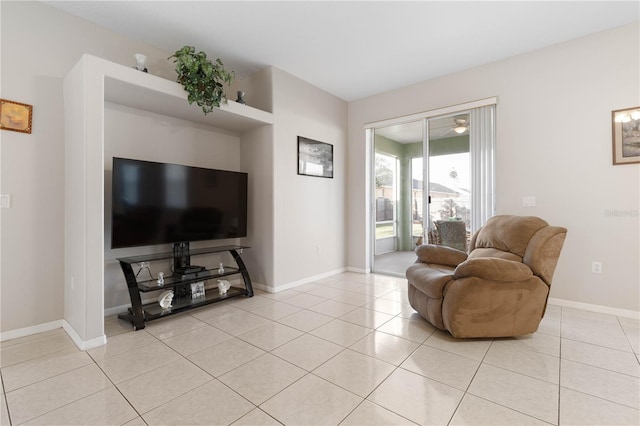 living room featuring ceiling fan and light tile patterned floors