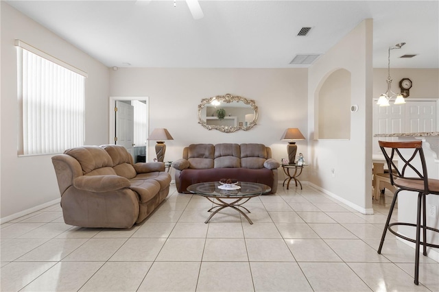 54 Fieldstone Ln, Palm Coast, FL 32137 - living area with light tile patterned flooring, ceiling fan, a chandelier, and arched walkways