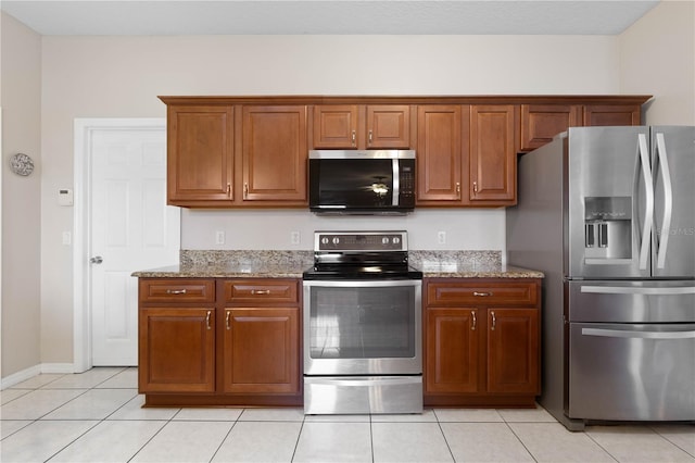 54 Fieldstone Ln, Palm Coast, FL 32137 - kitchen featuring stainless steel appliances, light stone counters, and brown cabinetry