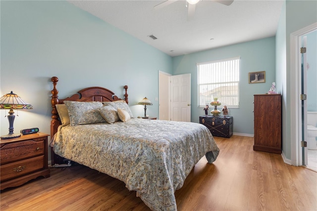 bedroom with connected bathroom, light hardwood / wood-style floors, and ceiling fan