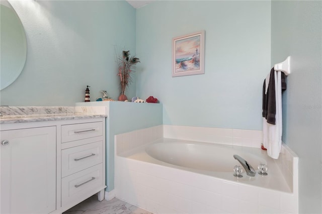 bathroom with vanity and a relaxing tiled tub