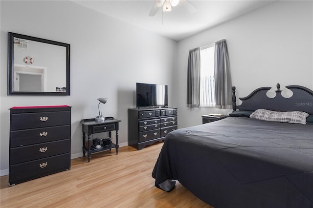 bedroom with light hardwood / wood-style floors and ceiling fan