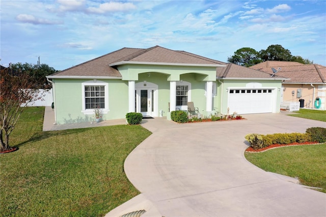 view of front of home with a front lawn and a garage