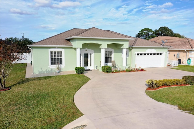 54 Fieldstone Ln, Palm Coast, FL 32137 - view of front facade with concrete driveway, stucco siding, an attached garage, and roof with shingles