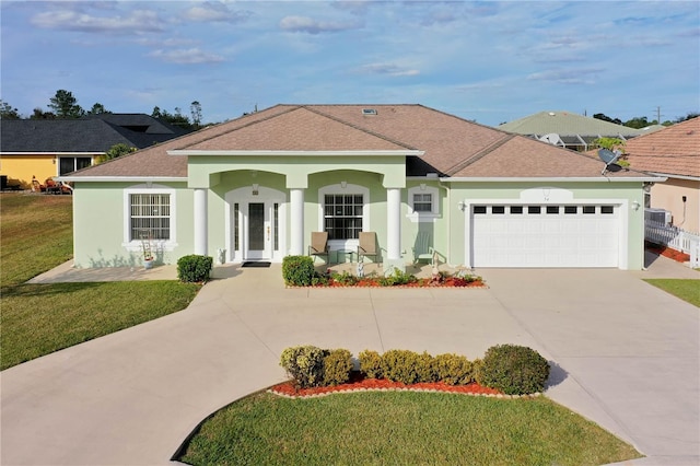 54 Fieldstone Ln, Palm Coast, FL 32137 - mediterranean / spanish-style house featuring driveway, stucco siding, a garage, and a shingled roof