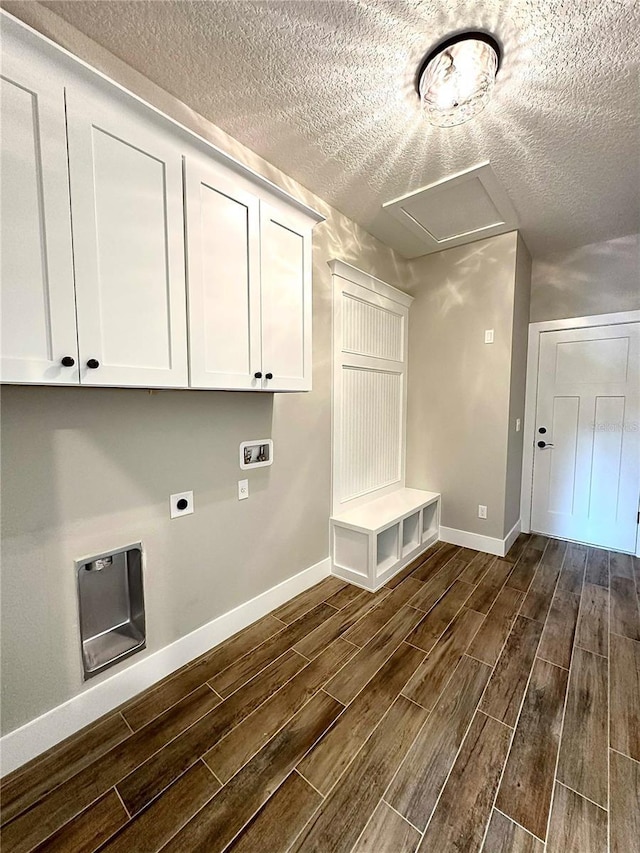 clothes washing area featuring a textured ceiling, dark hardwood / wood-style floors, and hookup for an electric dryer