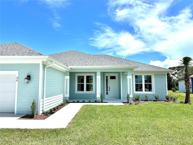 36 Armand Beach Dr, Palm Coast, FL 32137 - ranch-style house with an attached garage, a front lawn, covered porch, and roof with shingles