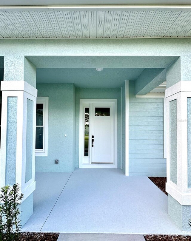 36 Armand Beach Dr, Palm Coast, FL 32137 - property entrance featuring stucco siding