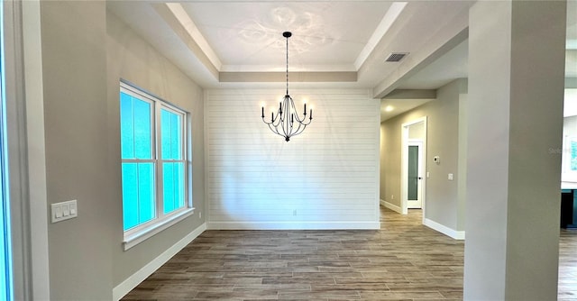 36 Armand Beach Dr, Palm Coast, FL 32137 - unfurnished dining area with a chandelier, a tray ceiling, and wood finished floors