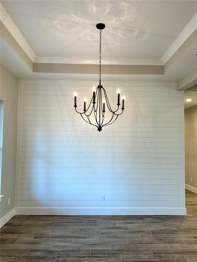 36 Armand Beach Dr, Palm Coast, FL 32137 - unfurnished dining area featuring wood tiled floors, a raised ceiling, a chandelier, and a textured ceiling