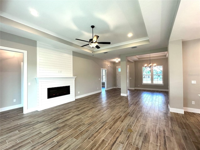 36 Armand Beach Dr, Palm Coast, FL 32137 - unfurnished living room featuring a raised ceiling, dark wood-type flooring, a chandelier, a fireplace, and a ceiling fan