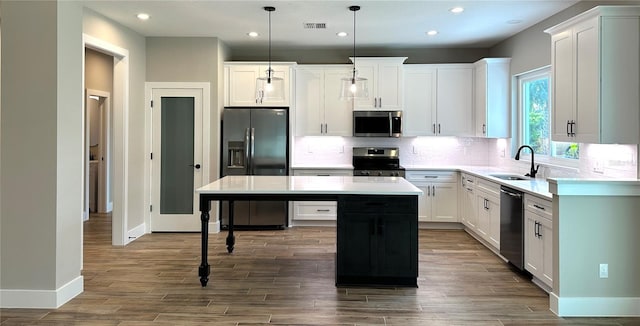 36 Armand Beach Dr, Palm Coast, FL 32137 - kitchen with stainless steel appliances, a center island, recessed lighting, tasteful backsplash, and light countertops
