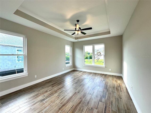 36 Armand Beach Dr, Palm Coast, FL 32137 - empty room with a tray ceiling, dark wood-type flooring, and a ceiling fan