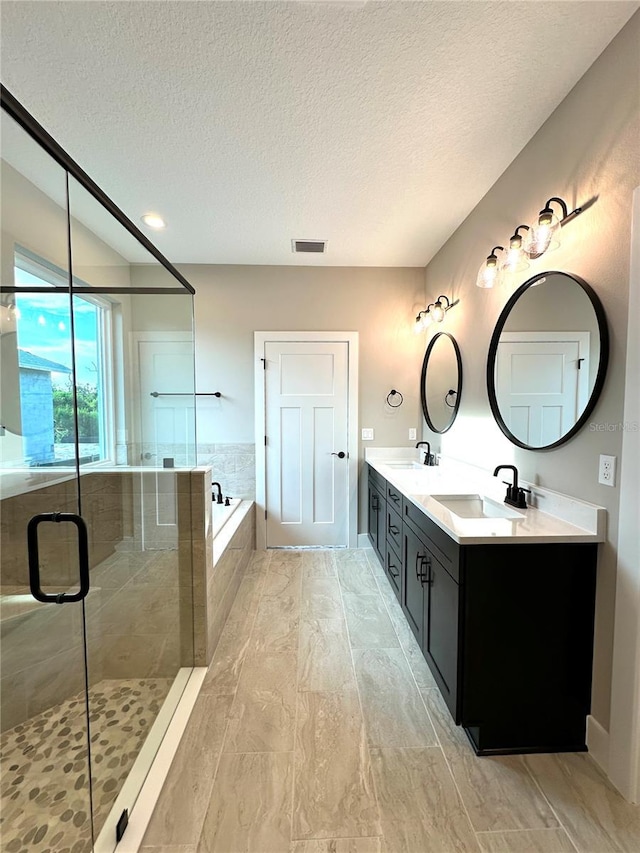 36 Armand Beach Dr, Palm Coast, FL 32137 - bathroom featuring a garden tub, double vanity, a textured ceiling, and a stall shower