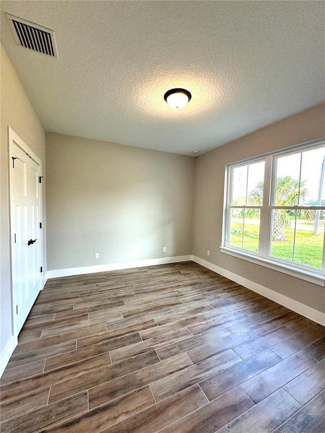 36 Armand Beach Dr, Palm Coast, FL 32137 - empty room featuring dark wood-type flooring and a textured ceiling