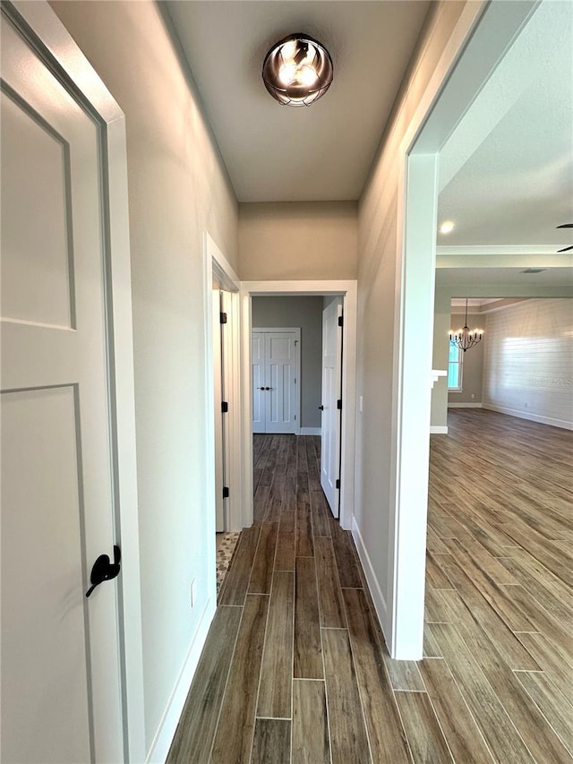 36 Armand Beach Dr, Palm Coast, FL 32137 - hallway featuring a chandelier and dark wood-type flooring