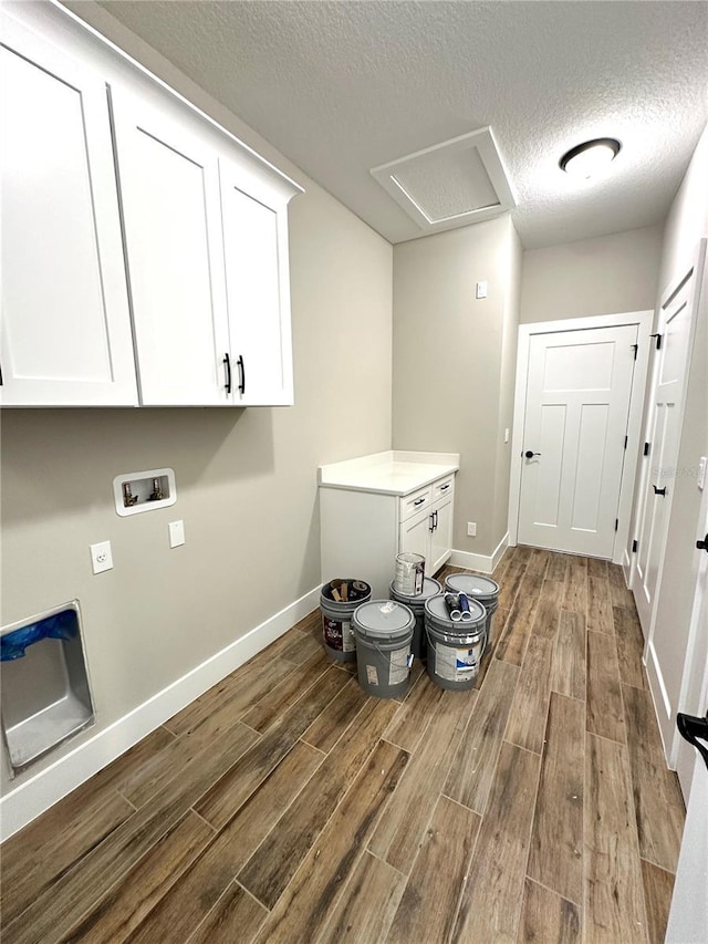 36 Armand Beach Dr, Palm Coast, FL 32137 - laundry room featuring cabinet space, wood finished floors, a textured ceiling, hookup for a washing machine, and attic access
