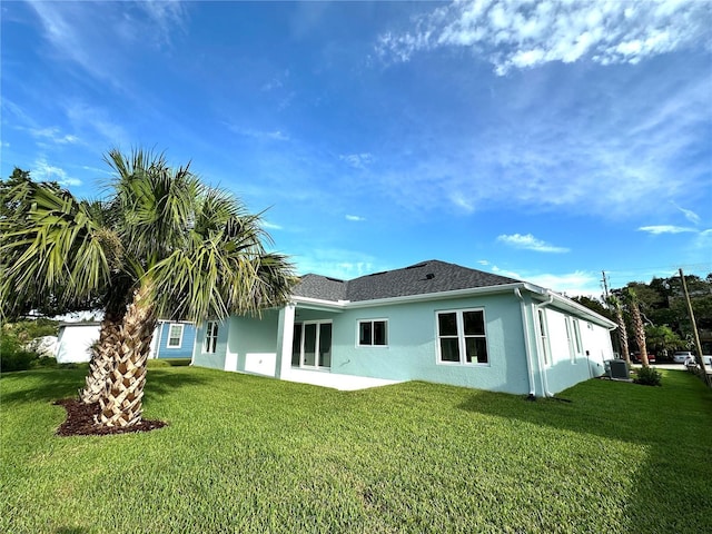 36 Armand Beach Dr, Palm Coast, FL 32137 - back of property featuring stucco siding and a yard