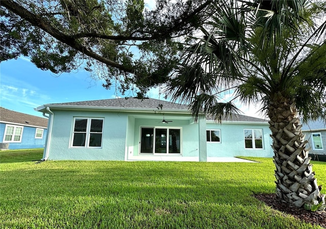 36 Armand Beach Dr, Palm Coast, FL 32137 - rear view of property with stucco siding, a lawn, a ceiling fan, and a patio area