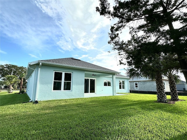 36 Armand Beach Dr, Palm Coast, FL 32137 - rear view of house with a yard, stucco siding, and ceiling fan