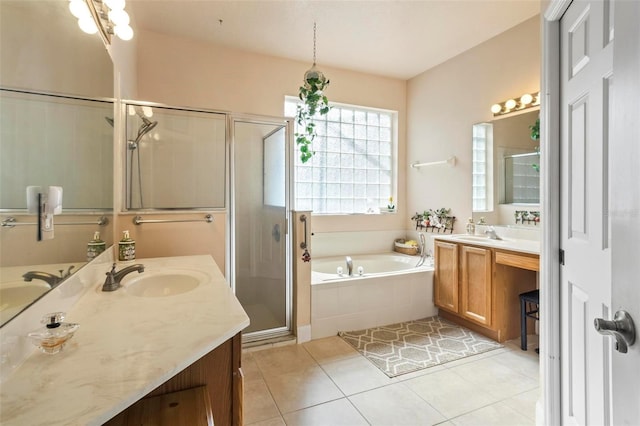 bathroom with tile patterned floors, independent shower and bath, and vanity