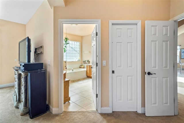 hall featuring light colored carpet