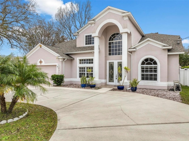 view of front of property with a garage and french doors