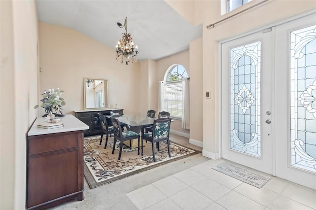 entryway with french doors, a notable chandelier, and light tile patterned floors