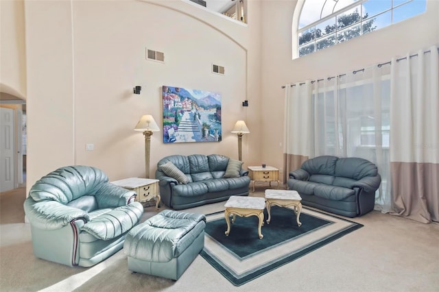 living room with a high ceiling and carpet