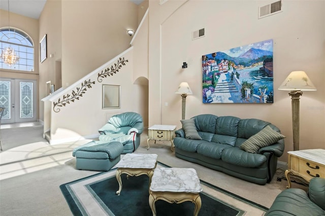 carpeted living room with a towering ceiling