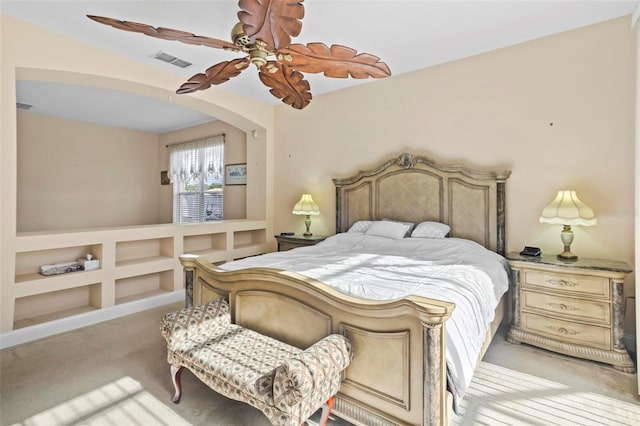 bedroom with ceiling fan and light carpet