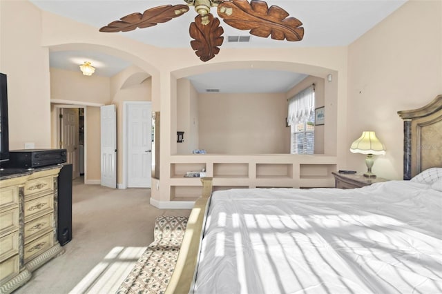 bedroom with ceiling fan and light carpet