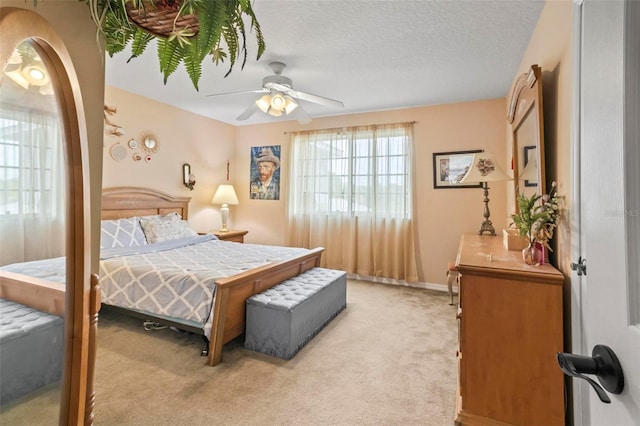 carpeted bedroom with a textured ceiling and ceiling fan