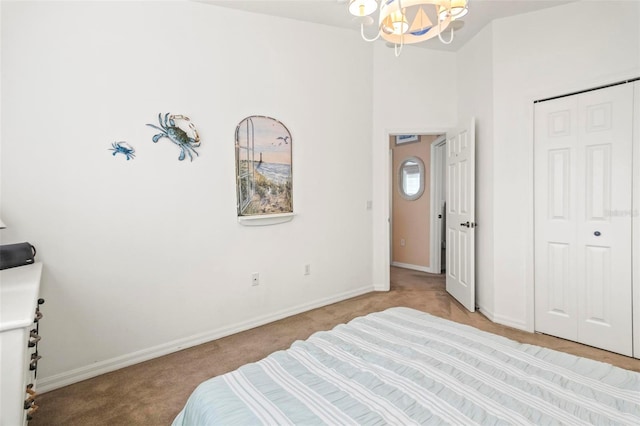 bedroom with a notable chandelier, a closet, and light carpet