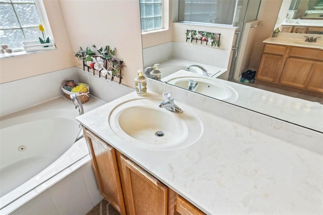 bathroom with vanity and shower with separate bathtub