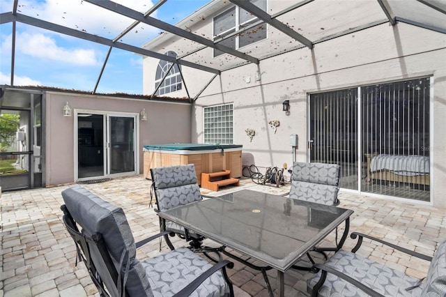 view of patio with a lanai and a hot tub