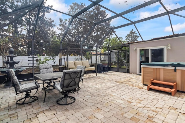 view of patio featuring a lanai and a hot tub