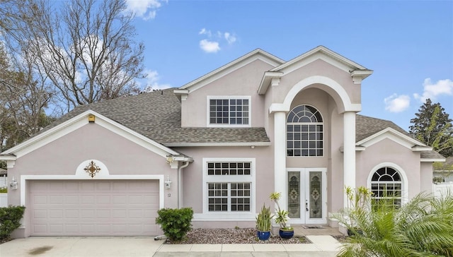 view of front of house featuring a garage and french doors