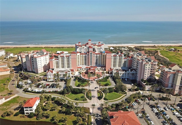 bird's eye view with a water view and a beach view