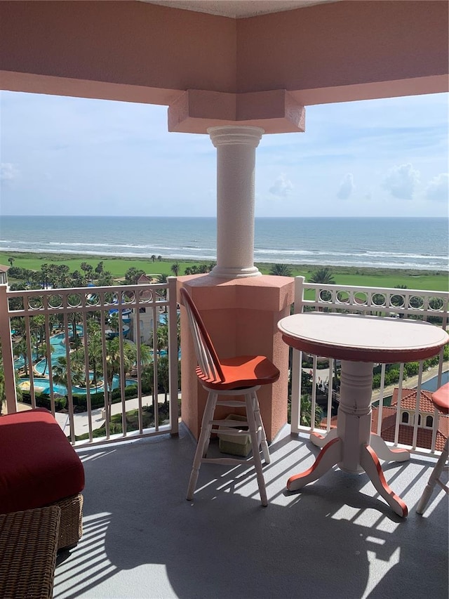 balcony with a beach view, a water view, and grilling area