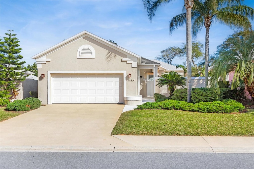 view of front of property featuring a garage and a front lawn