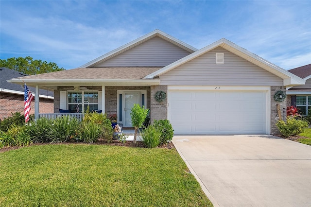 view of front of property featuring a front yard, a porch, and a garage