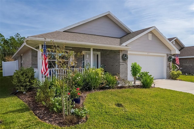 view of front facade with a front yard, a porch, and a garage