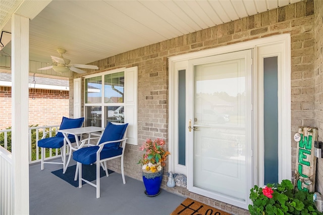 entrance to property with covered porch and ceiling fan