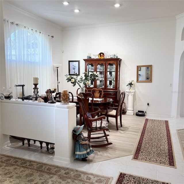 dining area featuring crown molding, light tile patterned flooring, and a textured ceiling